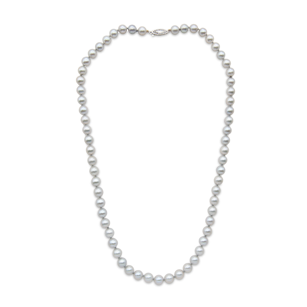 Strand of 7 to 7.5 millimeter spherical gray Akoya pearls measuring 21" with 14 karat white gold fishhook clasp.