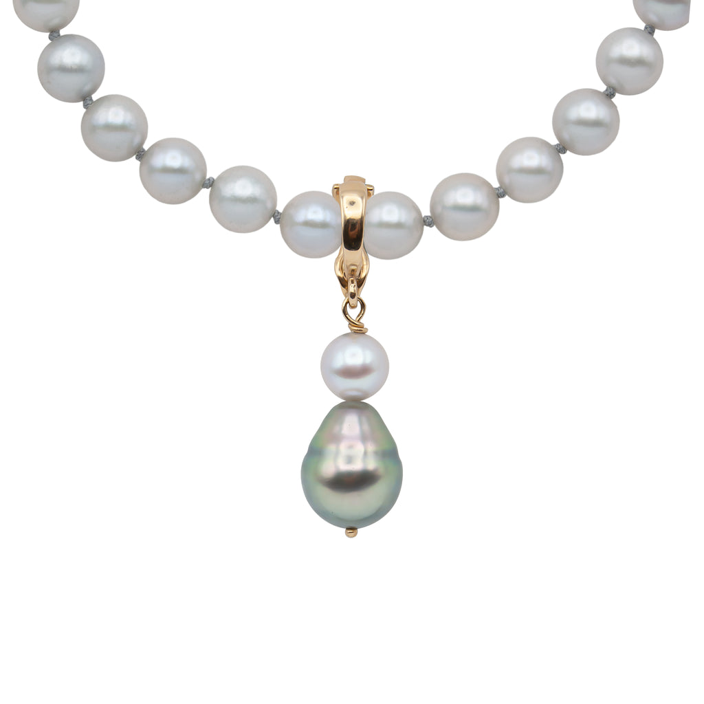 A 14 karat yellow gold pendant with a spherical gray Akoya pearl and pear shaped Tahitian pearl (on pearl strand).