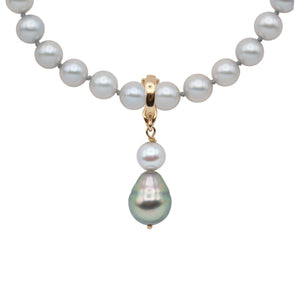 Strand of 7 to 7.5 millimeter spherical gray Akoya pearls with enhancer pendant.
